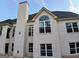 Exterior view of a newly constructed home with multiple windows and brick chimney at 2910 Battlecrest Dr, Decatur, GA 30034