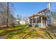 Wide angle view of home with screened-in porch with views of large, lush backyard at 707 Orleans Trce, Peachtree City, GA 30269