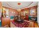 Formal dining room featuring elegant wallpaper, chandelier, and hardwood floors at 707 Orleans Trce, Peachtree City, GA 30269