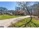 Two story brick and siding home with a long driveway on a large manicured lawn at 707 Orleans Trce, Peachtree City, GA 30269