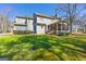 View of the rear of a large home with a screened in porch and a spacious green lawn at 707 Orleans Trce, Peachtree City, GA 30269