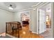 View of the hallway leading to the main bedroom with wood floors and detailed trim at 707 Orleans Trce, Peachtree City, GA 30269