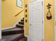 View of the home's carpeted staircase with decorative wall hangings at 707 Orleans Trce, Peachtree City, GA 30269