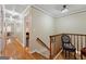 Hallway with hardwood floors leading to rooms with lots of light and decorative chair at 707 Orleans Trce, Peachtree City, GA 30269