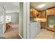 Hallway view showing laundry room with oak cabinets at 707 Orleans Trce, Peachtree City, GA 30269