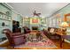 Bright living room with built-in shelving, brick fireplace, and classic furnishings at 707 Orleans Trce, Peachtree City, GA 30269