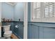 Charming powder room with wainscoting, plantation shutters, and tasteful decor at 707 Orleans Trce, Peachtree City, GA 30269