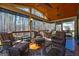 Relaxing screened porch with wicker furniture, ceiling fans, and scenic wooded views at 707 Orleans Trce, Peachtree City, GA 30269