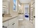 Bathroom featuring double vanities, white cabinets, and modern fixtures, offering a blend of style and functionality at 135 Red Maple Dr, Peachtree City, GA 30269