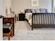 Bedroom featuring a sleigh bed with decorative pillows, complemented by a dresser and neutral-toned walls at 135 Red Maple Dr, Peachtree City, GA 30269