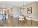 Charming dining area with wood floors, glass table, and kitchen access at 135 Red Maple Dr, Peachtree City, GA 30269