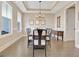 Elegant dining room featuring hardwood floors, a coffered ceiling, and plenty of natural light at 135 Red Maple Dr, Peachtree City, GA 30269