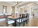 Beautiful dining room boasts hardwood floors, a large table, and a decorative chandelier at 135 Red Maple Dr, Peachtree City, GA 30269