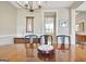 Elegant dining room with a glossy table, stylish chairs, and modern light fixture at 135 Red Maple Dr, Peachtree City, GA 30269