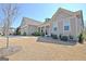 Beautiful single-story home showcasing a gray exterior, manicured lawn, and a side-entry two-car garage at 135 Red Maple Dr, Peachtree City, GA 30269