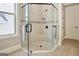 Close-up of a glass enclosed shower with grey tiled walls and floors, plus window at 135 Red Maple Dr, Peachtree City, GA 30269