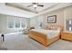 Spacious main bedroom with tray ceiling, plush carpet, and large windows at 135 Red Maple Dr, Peachtree City, GA 30269