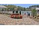 Community pool entrance with decorative brickwork, flowers and greenery at 135 Red Maple Dr, Peachtree City, GA 30269