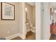 Cozy powder room featuring a pedestal sink and neutral decor at 135 Red Maple Dr, Peachtree City, GA 30269