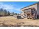 Spacious fenced backyard featuring a raised deck, patio, hot tub and play set at 157 Donovan Ave, Locust Grove, GA 30248