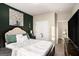 Bedroom with upholstered headboard and an accent wall at 157 Donovan Ave, Locust Grove, GA 30248