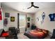 This bedroom has sporty decorations and a ceiling fan at 157 Donovan Ave, Locust Grove, GA 30248