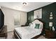 Bedroom with upholstered headboard and an accent wall at 157 Donovan Ave, Locust Grove, GA 30248