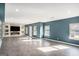 This bonus room features an accent wall with a mounted TV and modern fireplace at 157 Donovan Ave, Locust Grove, GA 30248