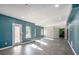 The bonus room features a sliding barn door and several windows to bring in natural light at 157 Donovan Ave, Locust Grove, GA 30248