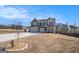 Two-story home featuring a two-car garage, neutral paint, brick accents, and a large driveway at 157 Donovan Ave, Locust Grove, GA 30248