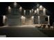 Two-story home featuring a two-car garage, neutral paint, brick accents, with exterior lighting at 157 Donovan Ave, Locust Grove, GA 30248