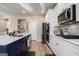 Bright kitchen features white cabinets, stainless steel appliances and large blue island with seating at 157 Donovan Ave, Locust Grove, GA 30248