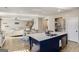 Open-concept kitchen and dining area features an island with seating and modern stainless steel appliances at 157 Donovan Ave, Locust Grove, GA 30248