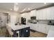 Bright kitchen features white cabinets, stainless steel appliances and large blue island with seating at 157 Donovan Ave, Locust Grove, GA 30248