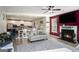 Open-concept living room featuring a fireplace and seamless transition to the kitchen at 157 Donovan Ave, Locust Grove, GA 30248