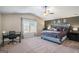 Spacious main bedroom with a vaulted ceiling, modern decor, accent wall, desk, and large window at 157 Donovan Ave, Locust Grove, GA 30248