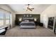 Spacious main bedroom with a vaulted ceiling, modern decor, accent wall, and large window at 157 Donovan Ave, Locust Grove, GA 30248