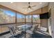 Screened in porch with ceiling fan and outdoor furniture; views of the trees beyond at 157 Donovan Ave, Locust Grove, GA 30248