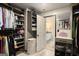 This walk-in closet has custom shelves, drawers, and access to the primary bathroom at 157 Donovan Ave, Locust Grove, GA 30248
