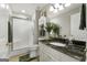 Bathroom features a granite countertop and shower with glass doors at 1160 Strath Clyde Way, Mcdonough, GA 30253