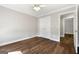 Bedroom with hardwood floors, white walls, and double door closet at 1160 Strath Clyde Way, Mcdonough, GA 30253