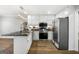Modern kitchen features white cabinets, granite countertops, and stainless steel appliances at 1160 Strath Clyde Way, Mcdonough, GA 30253