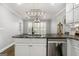 Kitchen island featuring stone countertops, stainless steel appliances, and bar seating at 1160 Strath Clyde Way, Mcdonough, GA 30253