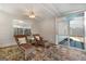Sun room with tiled floors, wicker furniture, and multiple windows at 1160 Strath Clyde Way, Mcdonough, GA 30253