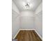 Walk-in closet with white walls, hardwood floors, and white shelving units at 1160 Strath Clyde Way, Mcdonough, GA 30253