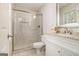 Updated bathroom with glass shower door, tiled shower, and modern vanity at 2050 Federal Rd, Roswell, GA 30075