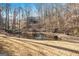 Picturesque pond with a fountain, surrounded by mature trees, creating a peaceful backyard retreat at 2050 Federal Rd, Roswell, GA 30075