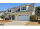 Inviting single-Gathering home showcasing a spacious two-car garage and covered front porch at 252 Turnbridge Cir, Peachtree City, GA 30269