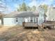 Back exterior view of the home features a wooden deck perfect for outdoor entertaining at 2260 Burdett Ridge Dr, South Fulton, GA 30349
