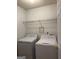 Convenient laundry room with washer, dryer, and a wire shelf for extra storage at 2260 Burdett Ridge Dr, South Fulton, GA 30349
